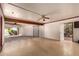 Spacious garage with a roll-up door, ceiling fan and convenient side access to the exterior at 325 E Sharon Ave, Phoenix, AZ 85022
