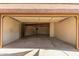 Large, empty garage with exposed beams, ready for parking and extra storage space at 325 E Sharon Ave, Phoenix, AZ 85022