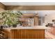 Bright kitchen with wood cabinets, breakfast bar, and plants at 325 E Sharon Ave, Phoenix, AZ 85022