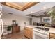 Open kitchen features a breakfast bar, oven and wood-trimmed ceiling at 325 E Sharon Ave, Phoenix, AZ 85022