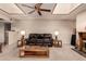 Comfortable living room features a fireplace and ceiling fan at 325 E Sharon Ave, Phoenix, AZ 85022