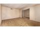 Spacious living room with neutral carpet flooring and light colored walls, awaiting personal touches at 325 E Sharon Ave, Phoenix, AZ 85022
