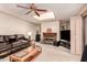 Comfortable living room features a fireplace, built-in bookshelves, and ceiling fan at 325 E Sharon Ave, Phoenix, AZ 85022