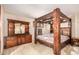 Bedroom with wooden four poster bed frame and matching dresser at 325 E Sharon Ave, Phoenix, AZ 85022
