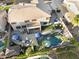 Aerial view of a private backyard oasis with a pool, patio, and lush landscaping at 3445 E Pageant Pl, Gilbert, AZ 85297
