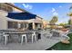 Outdoor kitchen and living space with a built-in bar, barbecue, and fire pit for relaxing and entertaining at 3445 E Pageant Pl, Gilbert, AZ 85297