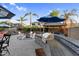 Great backyard with outdoor kitchen, fire pit, pool, palm trees and covered seating perfect for entertaining at 3445 E Pageant Pl, Gilbert, AZ 85297