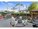Inviting backyard featuring a fire pit, pool, and covered seating area perfect for outdoor entertaining at 3445 E Pageant Pl, Gilbert, AZ 85297