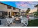 Backyard features a cozy fire pit, sparkling pool, spa and covered patio at 3445 E Pageant Pl, Gilbert, AZ 85297