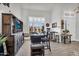 Bar area with custom bar, seating, TV, and dart board on tile floor at 3445 E Pageant Pl, Gilbert, AZ 85297