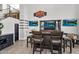 Bar area with custom built-in bar, TVs, shelving, and tile flooring at 3445 E Pageant Pl, Gilbert, AZ 85297