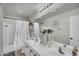 This bathroom has a double vanity, tile floors, and a shower/tub combo at 3445 E Pageant Pl, Gilbert, AZ 85297