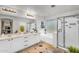 Bright bathroom with double vanity, separate tub, and glass-enclosed shower at 3445 E Pageant Pl, Gilbert, AZ 85297