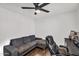 This bedroom offers a ceiling fan, hardwood floors, and a comfortable sofa at 3445 E Pageant Pl, Gilbert, AZ 85297