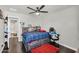 This bedroom features a ceiling fan, wood floors, and colorful decorations at 3445 E Pageant Pl, Gilbert, AZ 85297