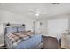 This bedroom includes a ceiling fan, wood floors, and a closet with sliding doors at 3445 E Pageant Pl, Gilbert, AZ 85297