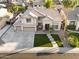 Beautiful two-story home featuring a three car garage, manicured lawn and walkway at 3445 E Pageant Pl, Gilbert, AZ 85297