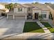 Stunning two-story residence with a spacious driveway, lush front yard, and elegant architectural details at 3445 E Pageant Pl, Gilbert, AZ 85297