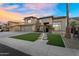 Stunning two-story home with a lush green lawn, stone pathway lighting, and a charming entrance with a 
