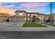 Beautiful two-story home with a manicured front yard, a three-car garage, and a charming stone-accented entrance at 3445 E Pageant Pl, Gilbert, AZ 85297