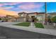 Inviting two-story home featuring a well-maintained lawn, stone accents, and a welcoming entrance with a 
