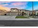 Gorgeous two-story home boasting a well-manicured front yard, a three-car garage, and elegant stone accents at 3445 E Pageant Pl, Gilbert, AZ 85297