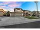 Charming two-story home with a spacious driveway, a three-car garage, and a meticulously maintained front yard at 3445 E Pageant Pl, Gilbert, AZ 85297