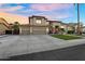 Attractive two-story home with a spacious driveway, a three-car garage, and manicured landscaping with palm trees at 3445 E Pageant Pl, Gilbert, AZ 85297