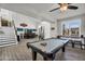 Large game room boasts pool table, bar area, and easy access to staircase and front door at 3445 E Pageant Pl, Gilbert, AZ 85297