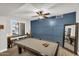 An amazing game room with pool table, a custom accent wall, and stylish furnishings at 3445 E Pageant Pl, Gilbert, AZ 85297