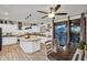 Bright open kitchen featuring an island, granite counters, modern appliances, a dining area, and direct access to the outdoor pool at 3445 E Pageant Pl, Gilbert, AZ 85297