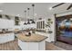 Bright kitchen featuring an island, granite counters, stainless steel appliances, and contemporary pendant lighting at 3445 E Pageant Pl, Gilbert, AZ 85297
