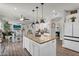 Bright and open kitchen with large island, granite counters, stainless appliances, and open to dining area and living room at 3445 E Pageant Pl, Gilbert, AZ 85297