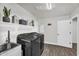 Modern laundry room featuring sleek black washer and dryer, ample storage, and convenient sink at 3445 E Pageant Pl, Gilbert, AZ 85297