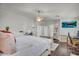 Spacious main bedroom with ensuite access, a large bed, and a ceiling fan at 3445 E Pageant Pl, Gilbert, AZ 85297