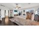 Large main bedroom with dark wood floors, ceiling fan, and bright natural light at 3445 E Pageant Pl, Gilbert, AZ 85297