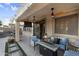 Outdoor patio features a ceiling fan, tv, fireplace and comfortable seating, creating an inviting atmosphere at 3445 E Pageant Pl, Gilbert, AZ 85297