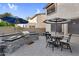 Cozy patio area with built-in barbecue and an outdoor dining set, perfect for enjoying meals outside at 3445 E Pageant Pl, Gilbert, AZ 85297