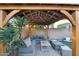 Stylish covered outdoor seating area with comfortable furniture and a decorative overhead structure at 3445 E Pageant Pl, Gilbert, AZ 85297
