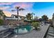 Backyard features a sparkling pool with waterfall, spa, BBQ, and covered patio at 3445 E Pageant Pl, Gilbert, AZ 85297