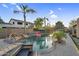 Resort-style pool featuring rock waterfall, lush landscaping, and outdoor seating areas at 3445 E Pageant Pl, Gilbert, AZ 85297