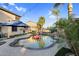Backyard pool with palm trees, waterfall features, lounge area, and lush landscaping at 3445 E Pageant Pl, Gilbert, AZ 85297