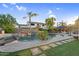 Relaxing backyard pool with waterfall, seating, lush landscaping, and paver decking at 3445 E Pageant Pl, Gilbert, AZ 85297