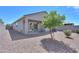 Private back yard with a covered patio and low-maintenance landscaping; features a mature shade tree at 36522 W Santa Monica Ave, Maricopa, AZ 85138