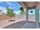 A private backyard offers peaceful serenity with a small tree, bushes, rock landscape, and block fence at 36522 W Santa Monica Ave, Maricopa, AZ 85138