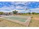 Community basketball court featuring a full court, basketball hoop, and grassy surroundings at 36522 W Santa Monica Ave, Maricopa, AZ 85138