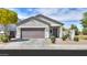 Charming single-story home with a well-manicured front yard and a neutral color scheme at 36522 W Santa Monica Ave, Maricopa, AZ 85138