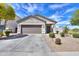 Charming single-story home with a well-manicured front yard and a neutral color scheme at 36522 W Santa Monica Ave, Maricopa, AZ 85138