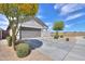 Single-story house featuring a xeriscaped front yard with a driveway and a mature desert tree at 36522 W Santa Monica Ave, Maricopa, AZ 85138