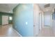 Spacious hallway showcases neutral tile flooring, smooth walls, and access to other areas of the home at 36522 W Santa Monica Ave, Maricopa, AZ 85138